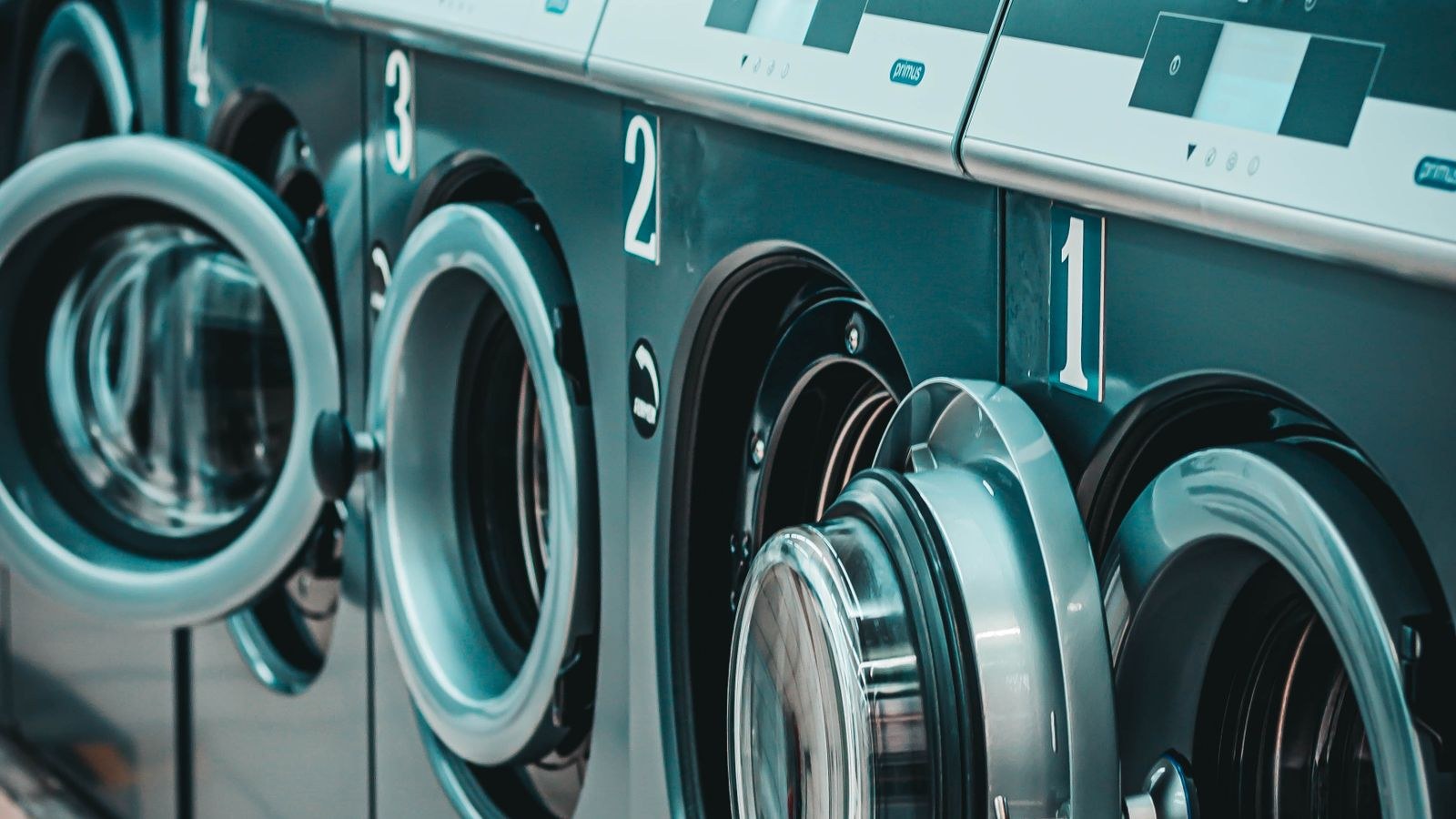 Row of modern washing machines showing different capacity and efficiency ratings