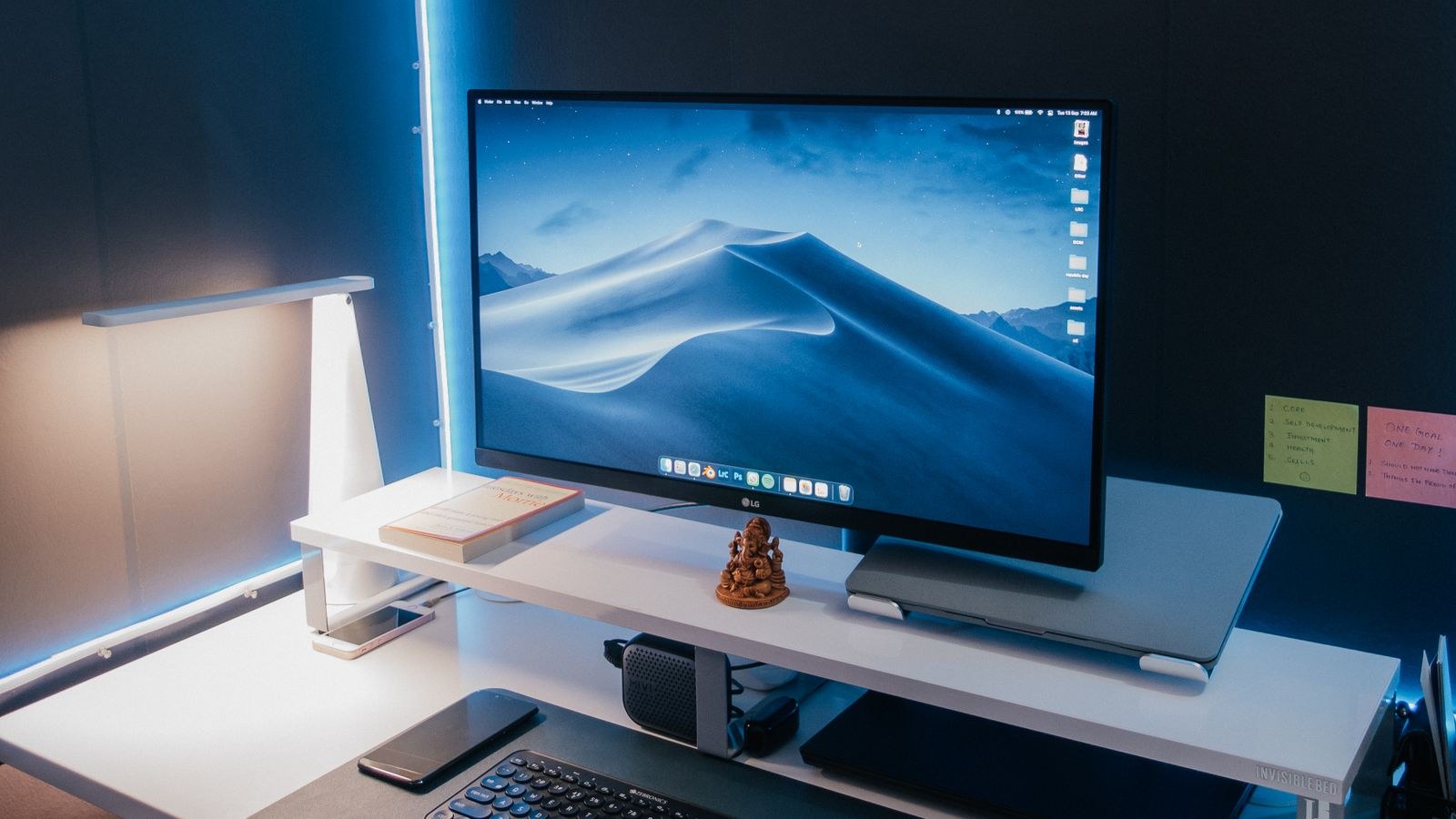 Computer desk setup lit with LED strip lighting