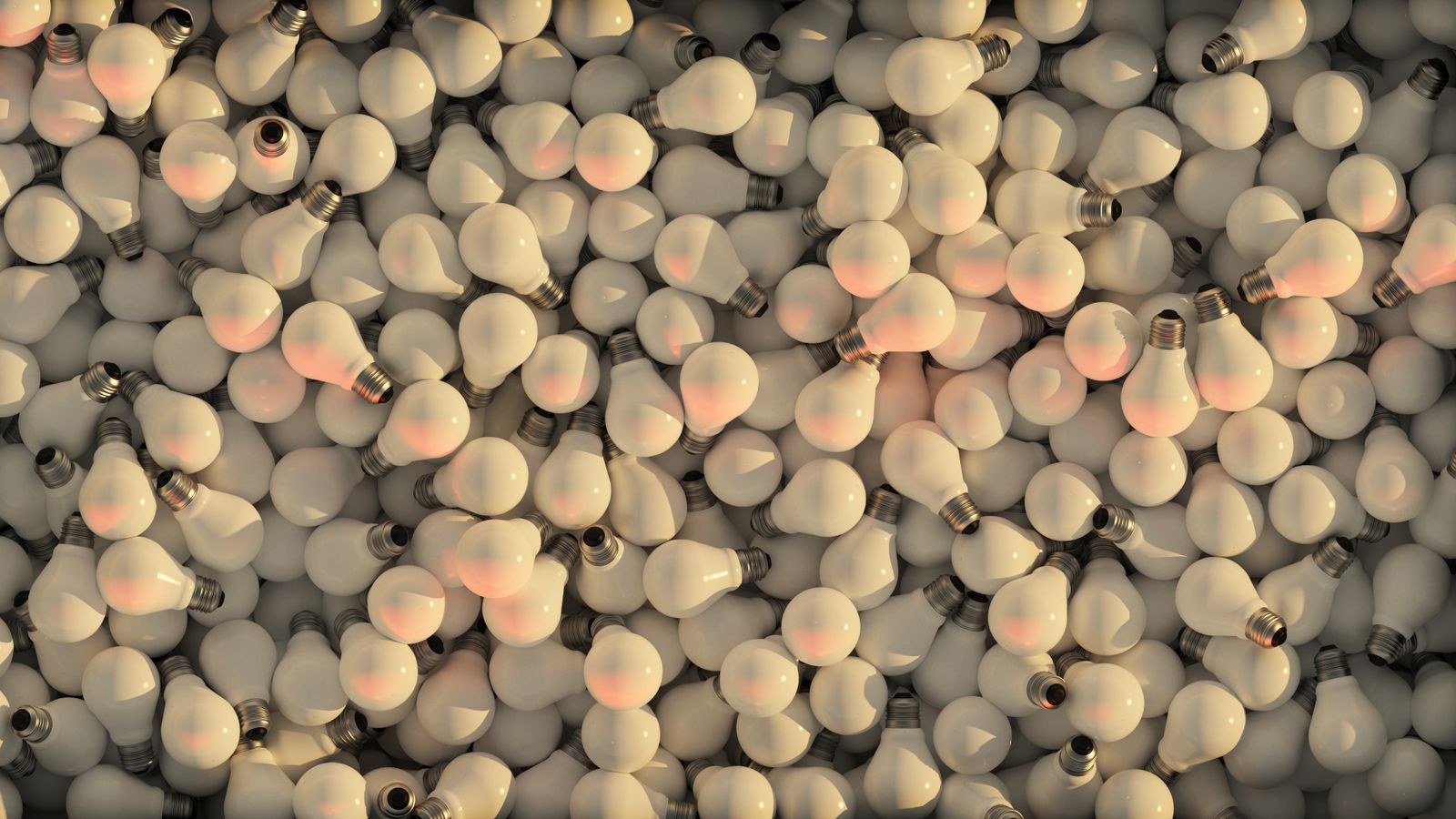 Pile of traditional incandescent light bulbs showing filaments