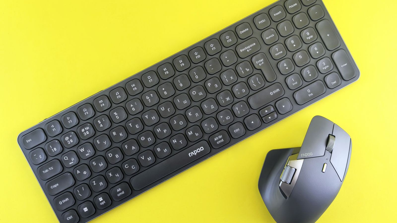 Wireless low profile keyboard and mouse set against a bright background
