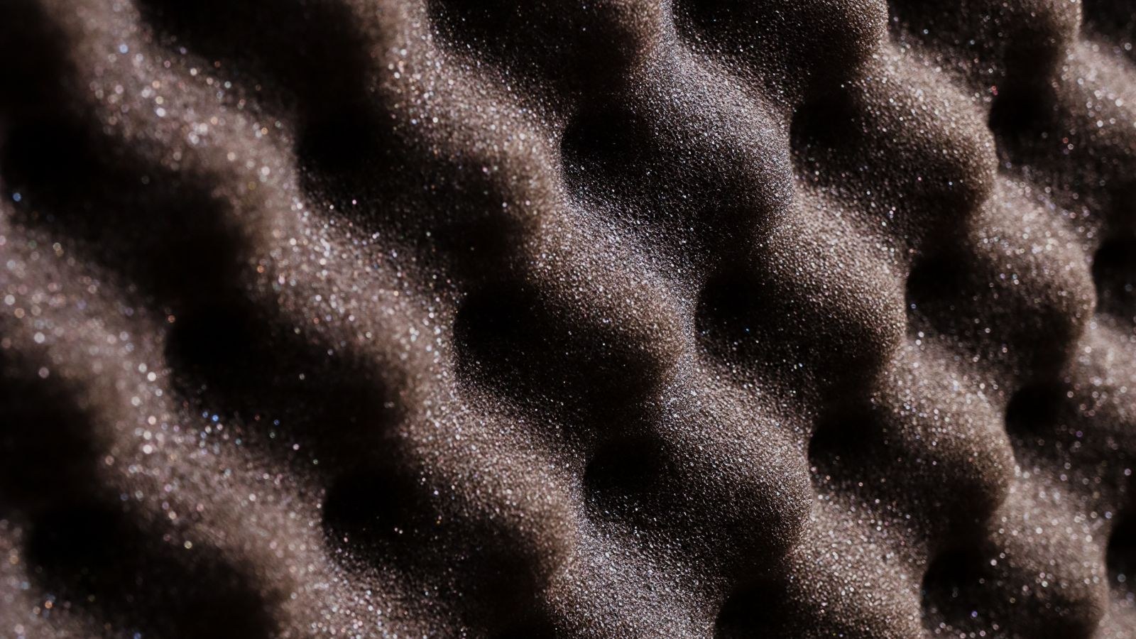 Acoustic foam panels on a wall reducing echo in a home office