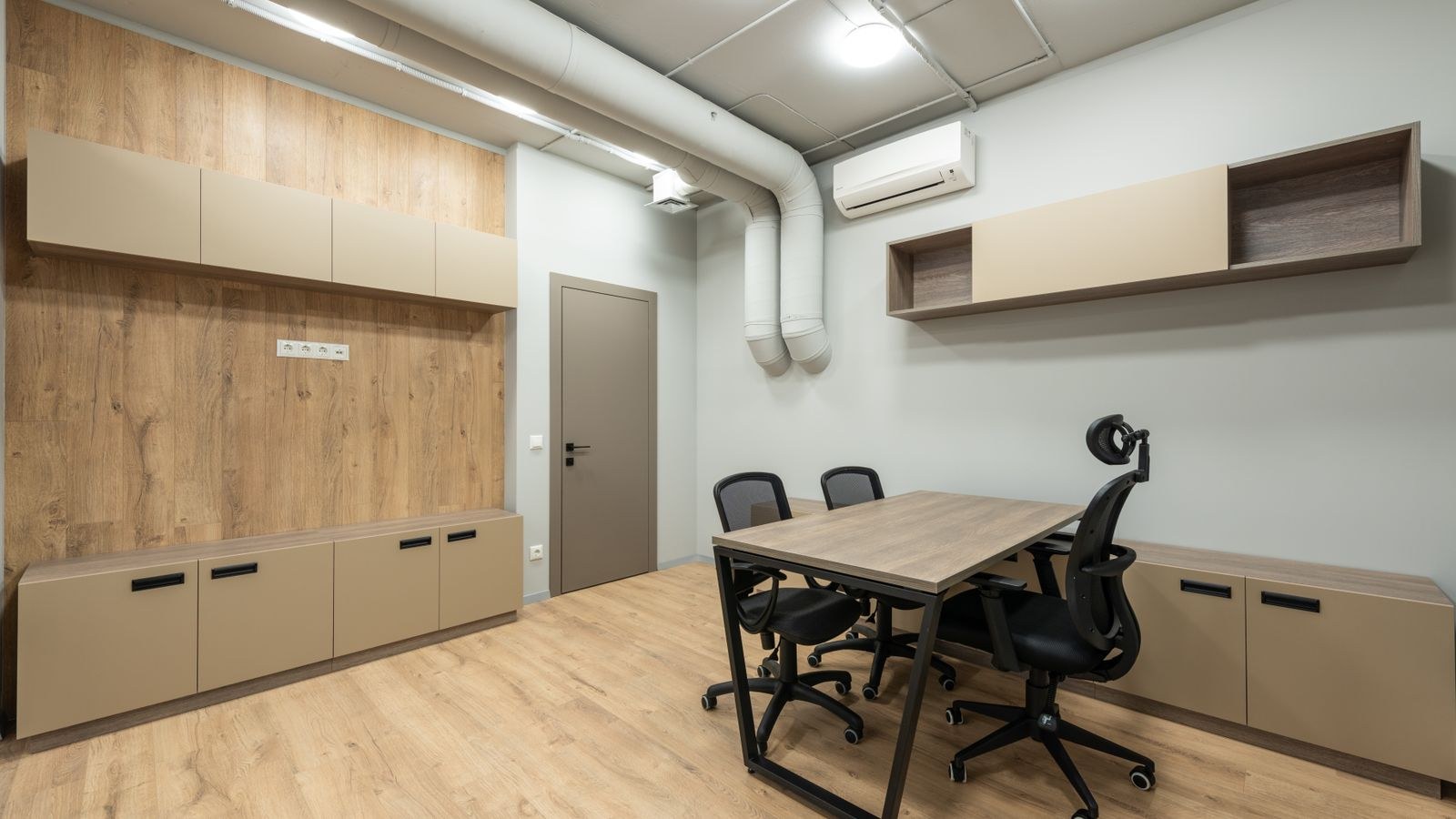 Home office with wooden furniture and soft surfaces that reduce room echo