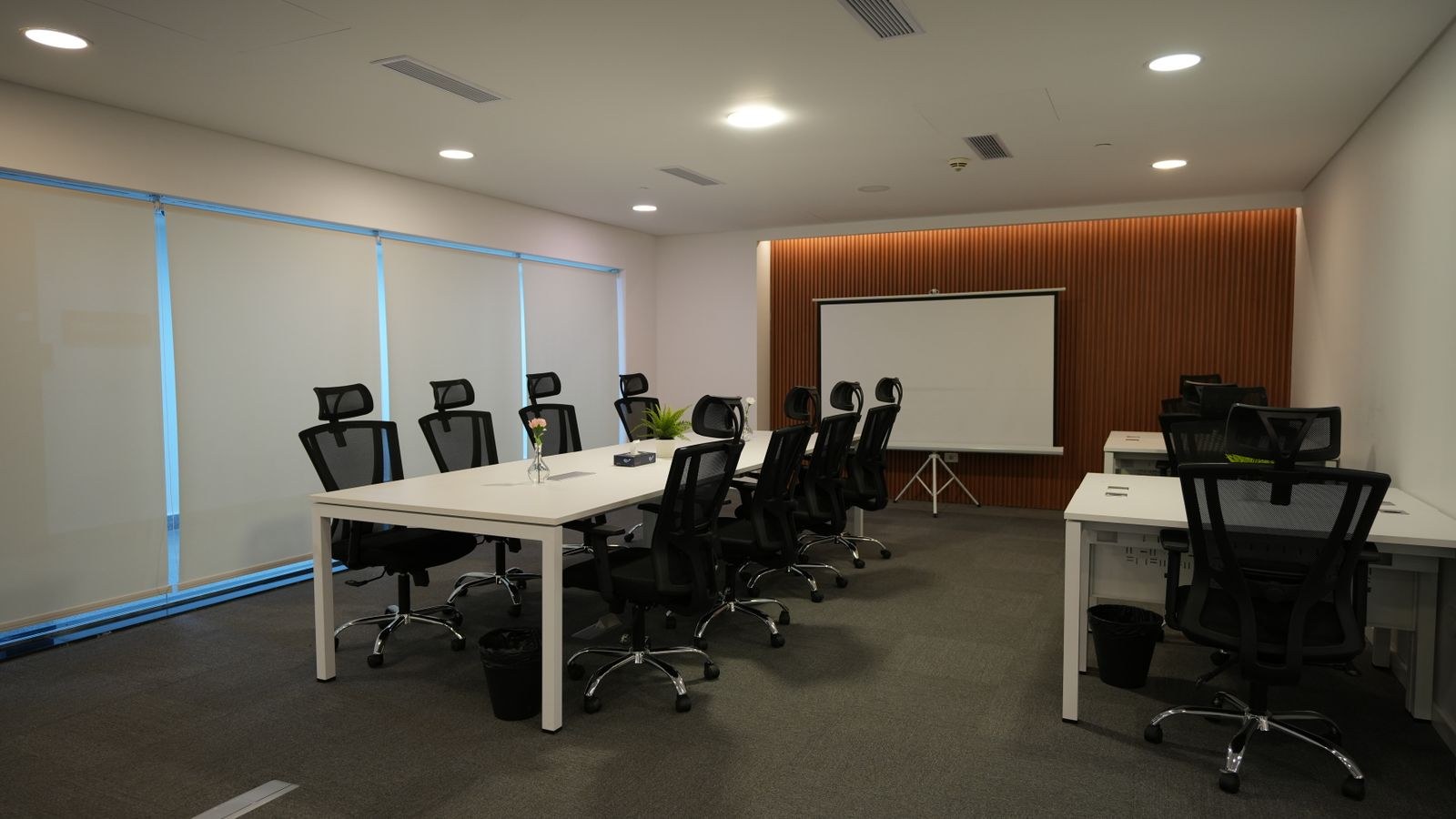 Coworking space with ergonomic office chairs and large shared tables