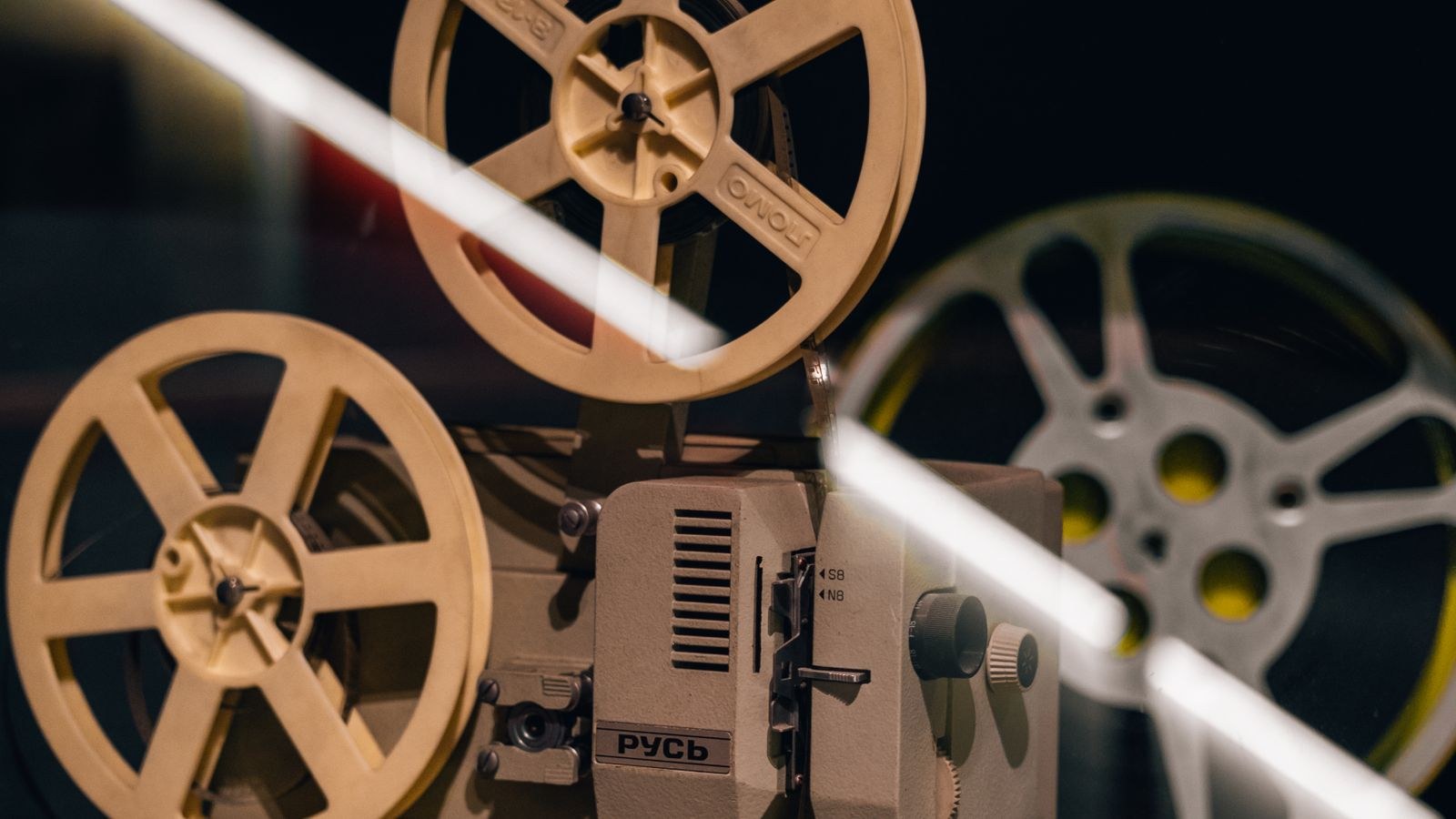 Home cinema projector mounted for correct throw distance in a dark room