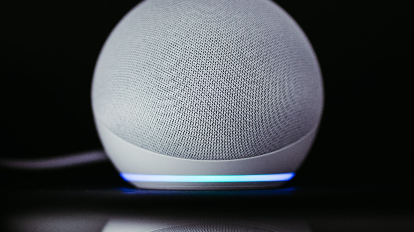 Compact smart speaker with glowing base used for voice control during ecosystem migration