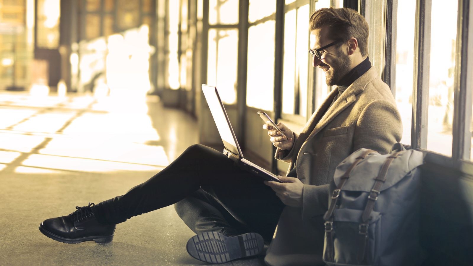 Digital nomad using a laptop and smartphone while travelling with portable internet gear