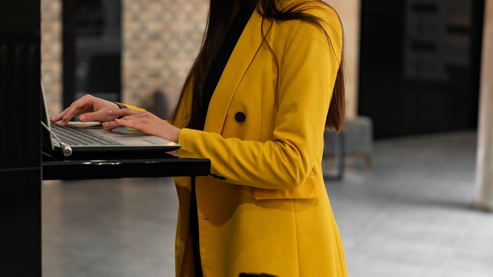 Business traveller setting up a laptop in a hotel lobby with a portable travel router