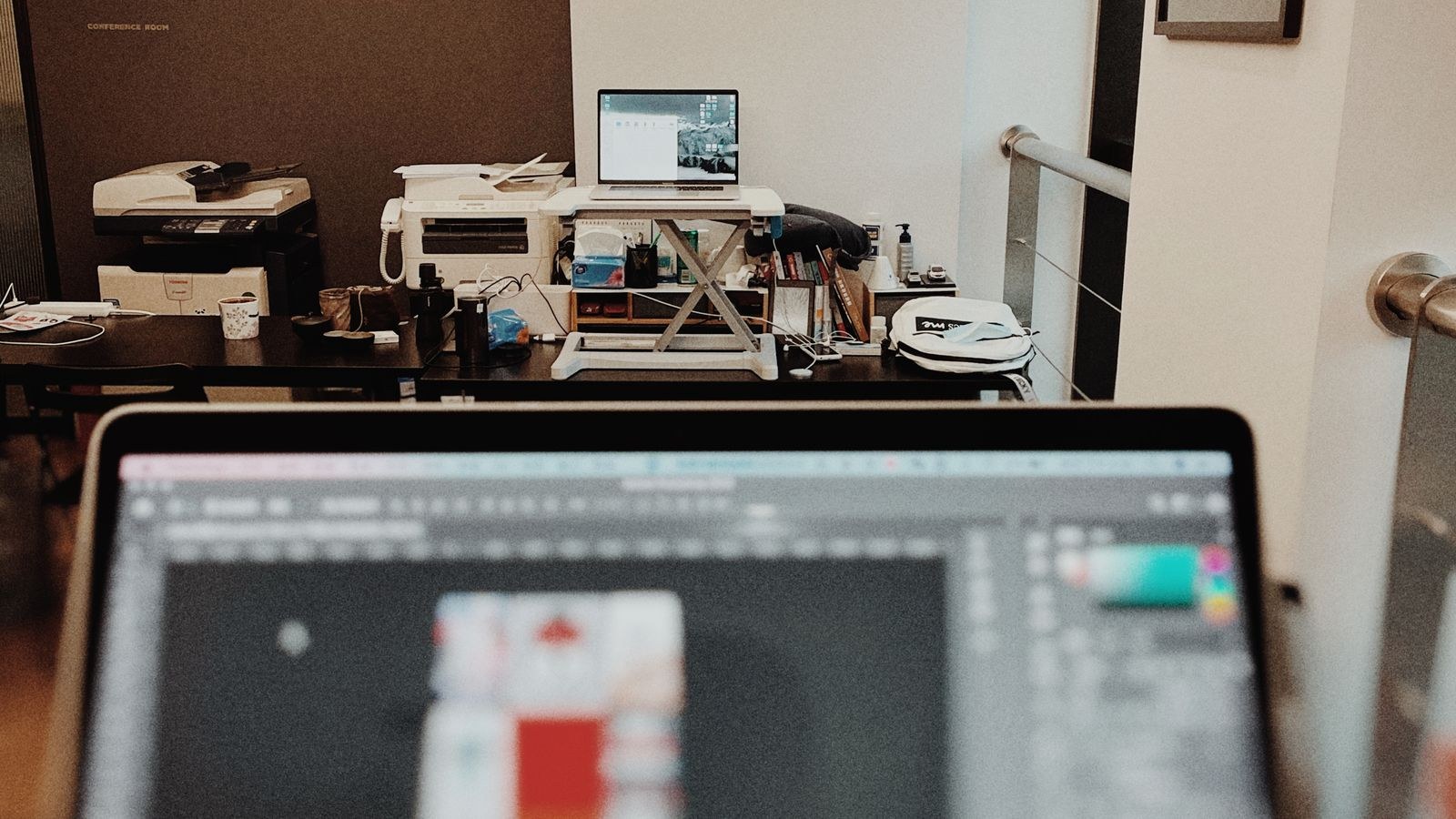 Dual monitor arm setup with two screens mounted above a workstation desk