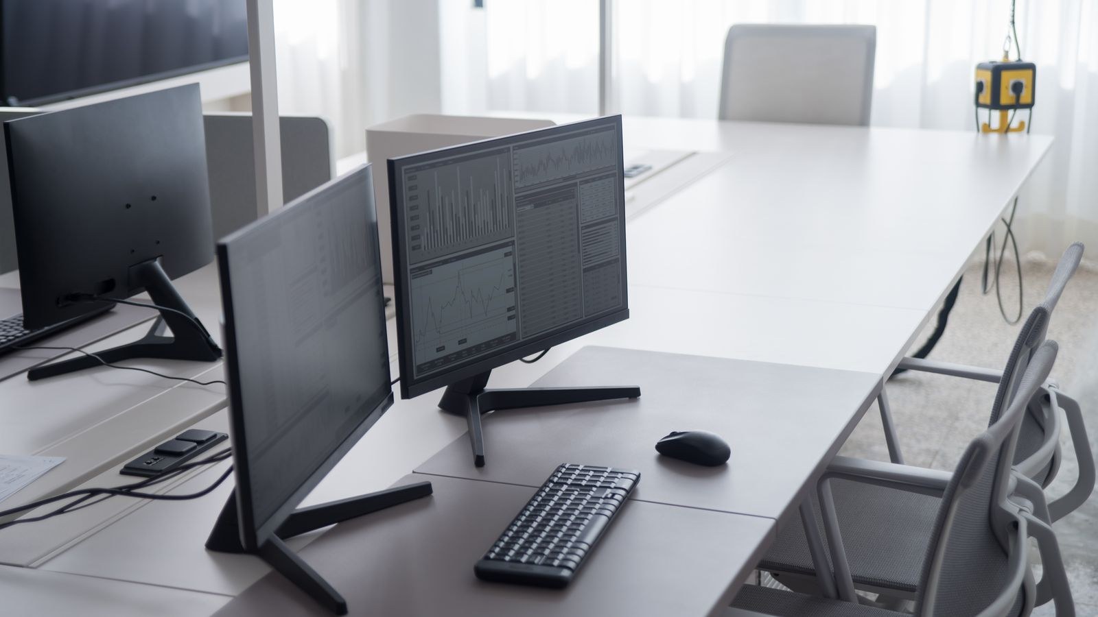 Clean office desk with dual monitors mounted to save desk surface space