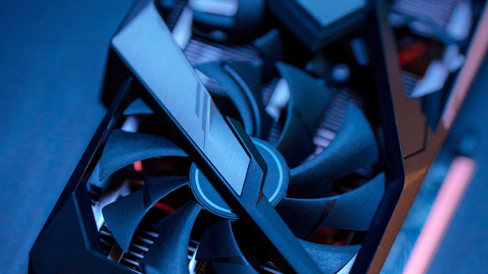 Graphics card cooler with multiple fans dissipating GPU heat under load