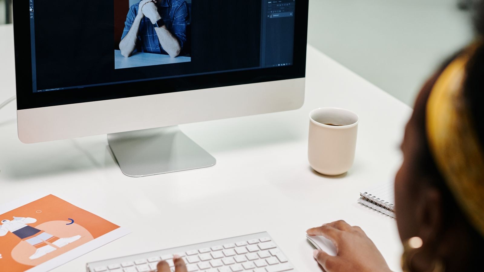 Video editor grading footage on a large calibrated desktop monitor