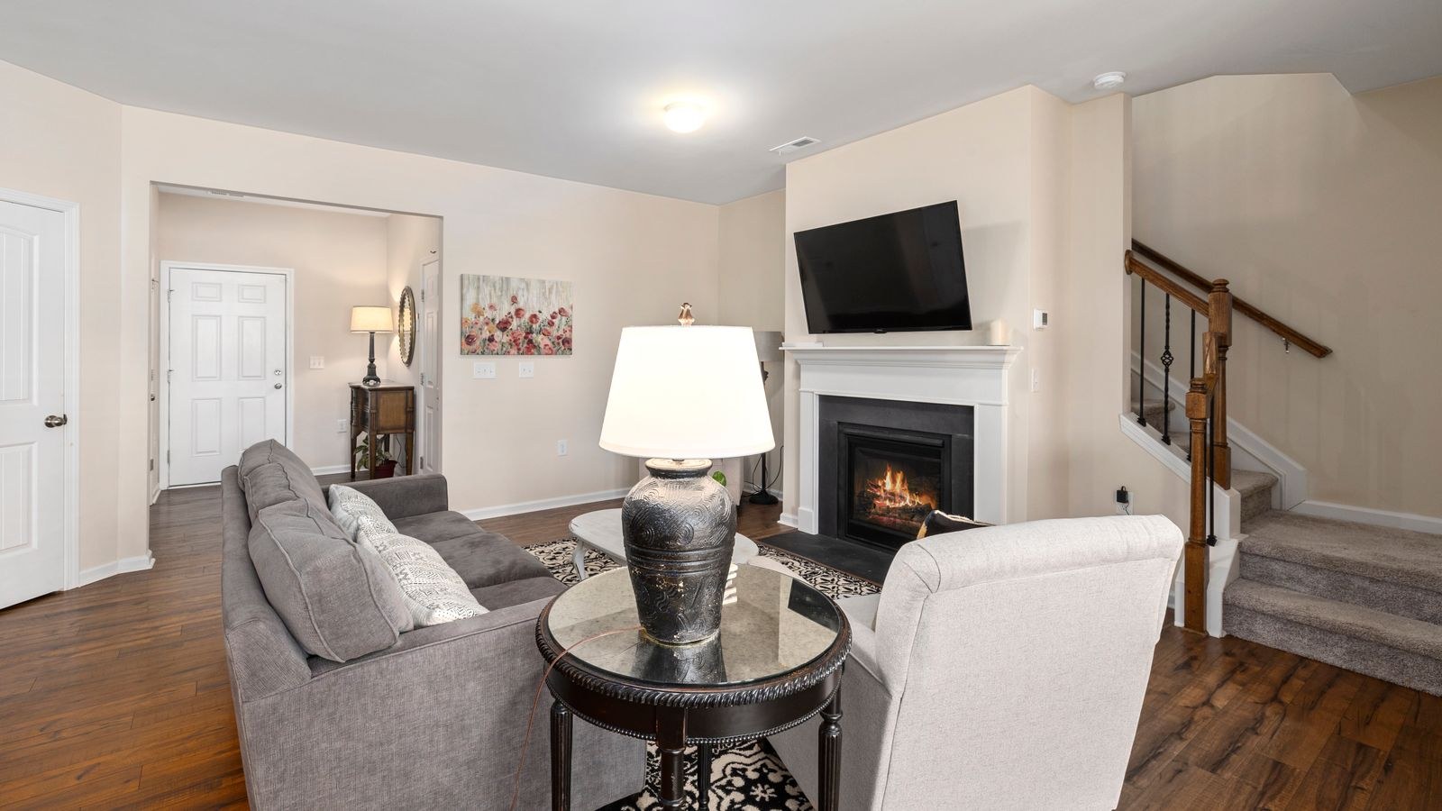 Living room fireplace with mantel and seating arranged for viewing