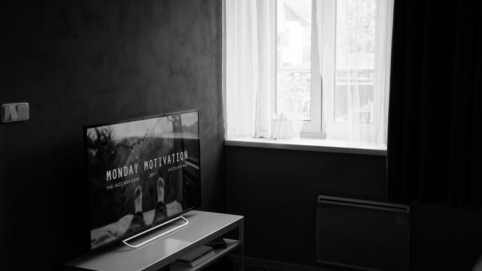 Television on a media console mount with soundbar in a small apartment