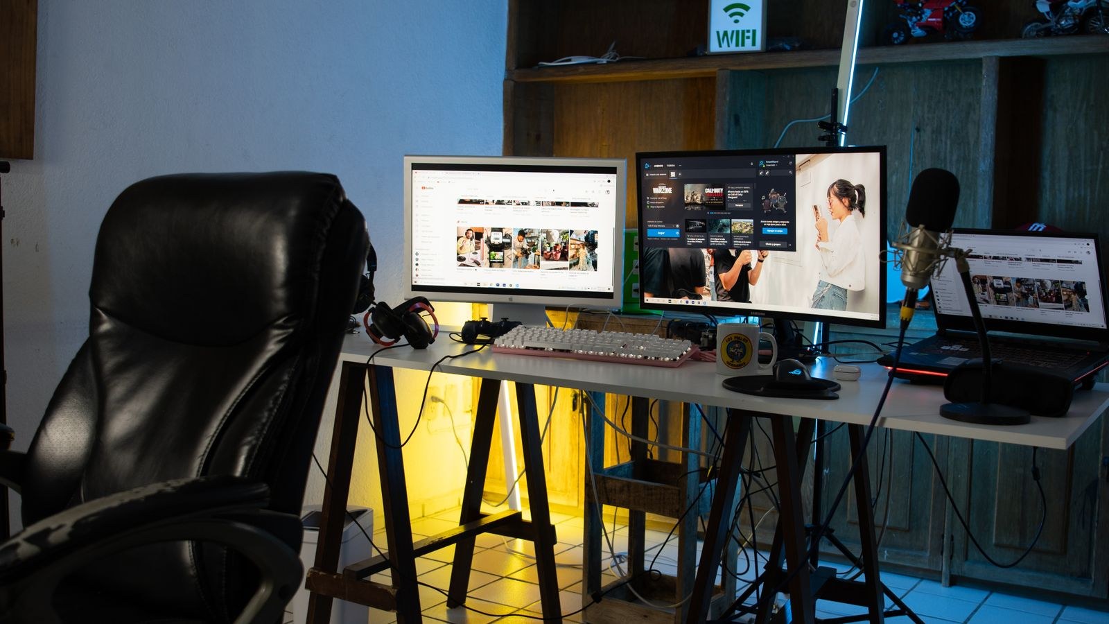 Contemporary home office desk with dual monitors, keyboard and microphone