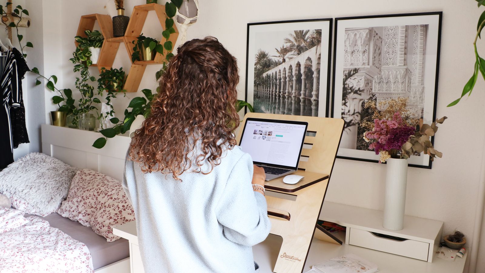 Standing desk in a home office with mounted monitor arm