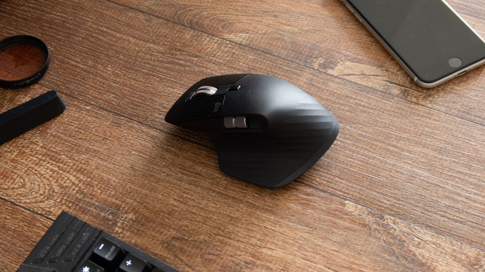 Overhead view of computer peripherals including a mouse and keyboard on a wooden desk