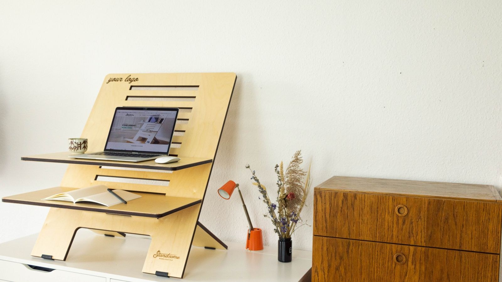 Minimalist standing desk with laptop set up in a home office after a move