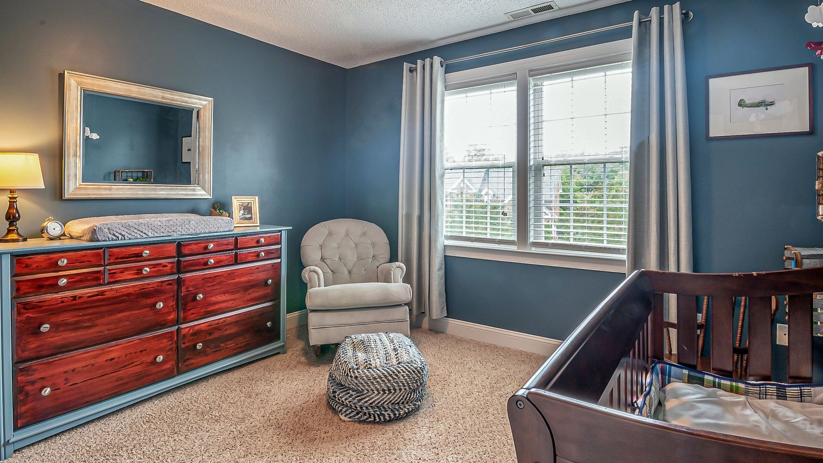 Comfortable nursery armchair in a bright corner of a baby room