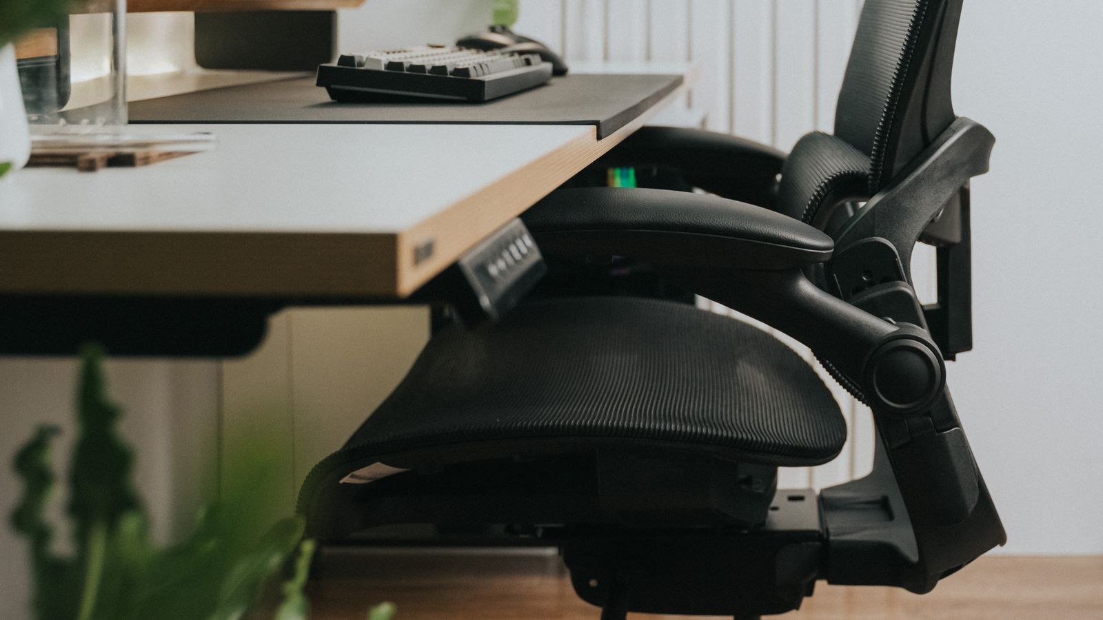 Ergonomic chair positioned at a minimalist desk setup