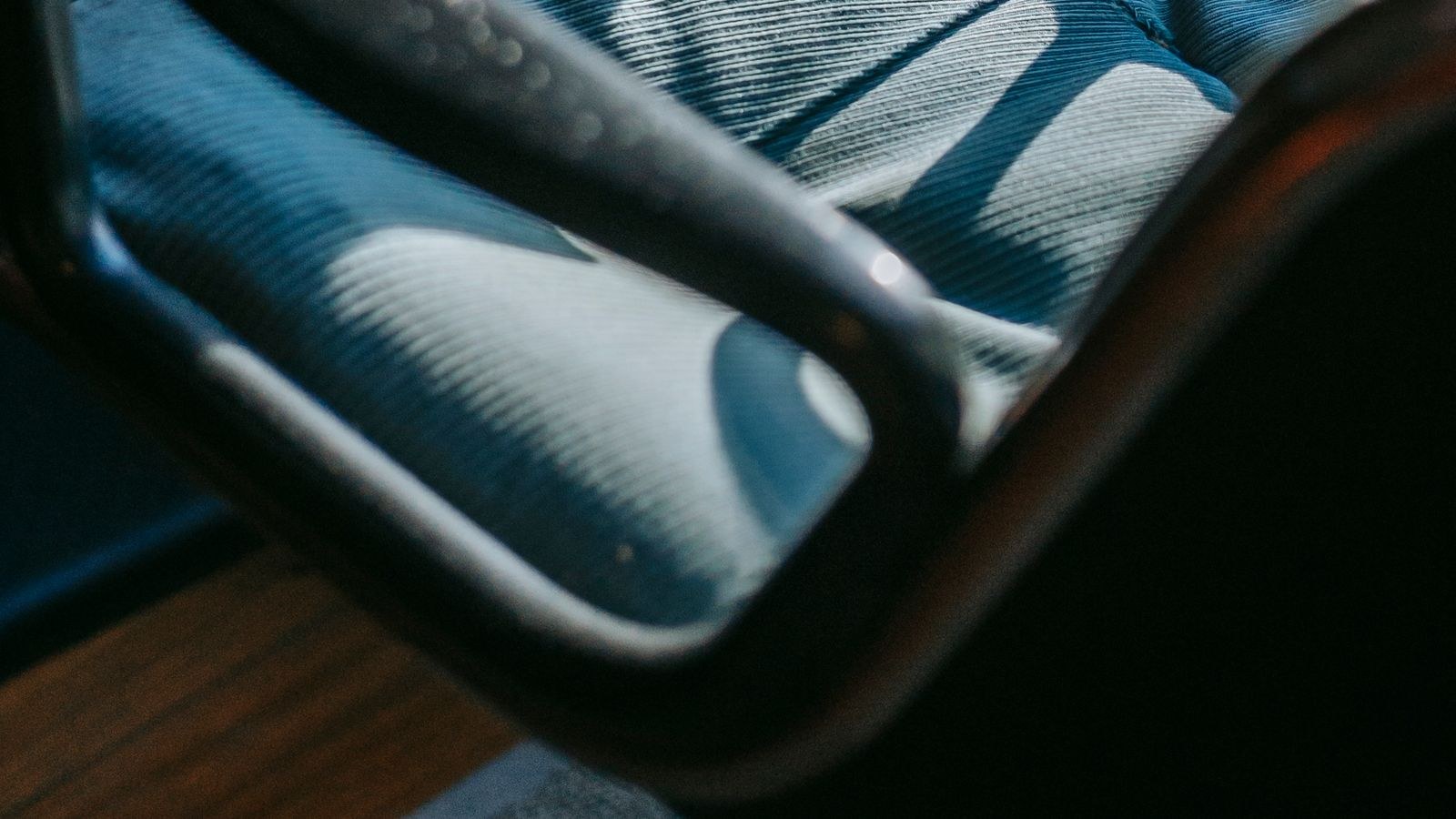 Comfortable office chair beside a wooden desk in natural light