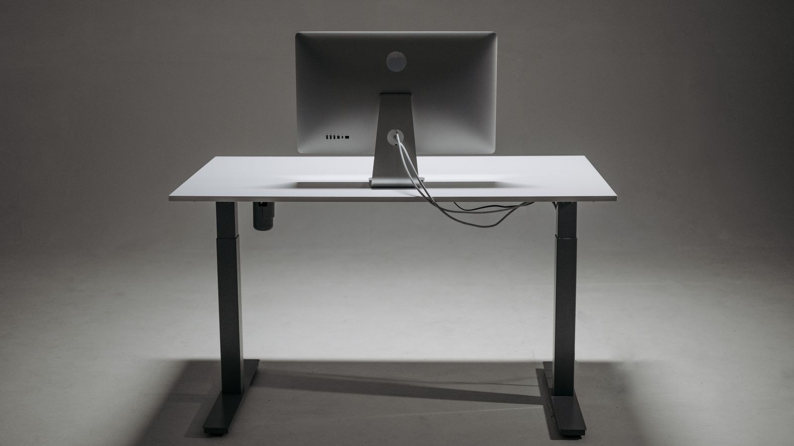 Cable management clips routing charging cords under a desk