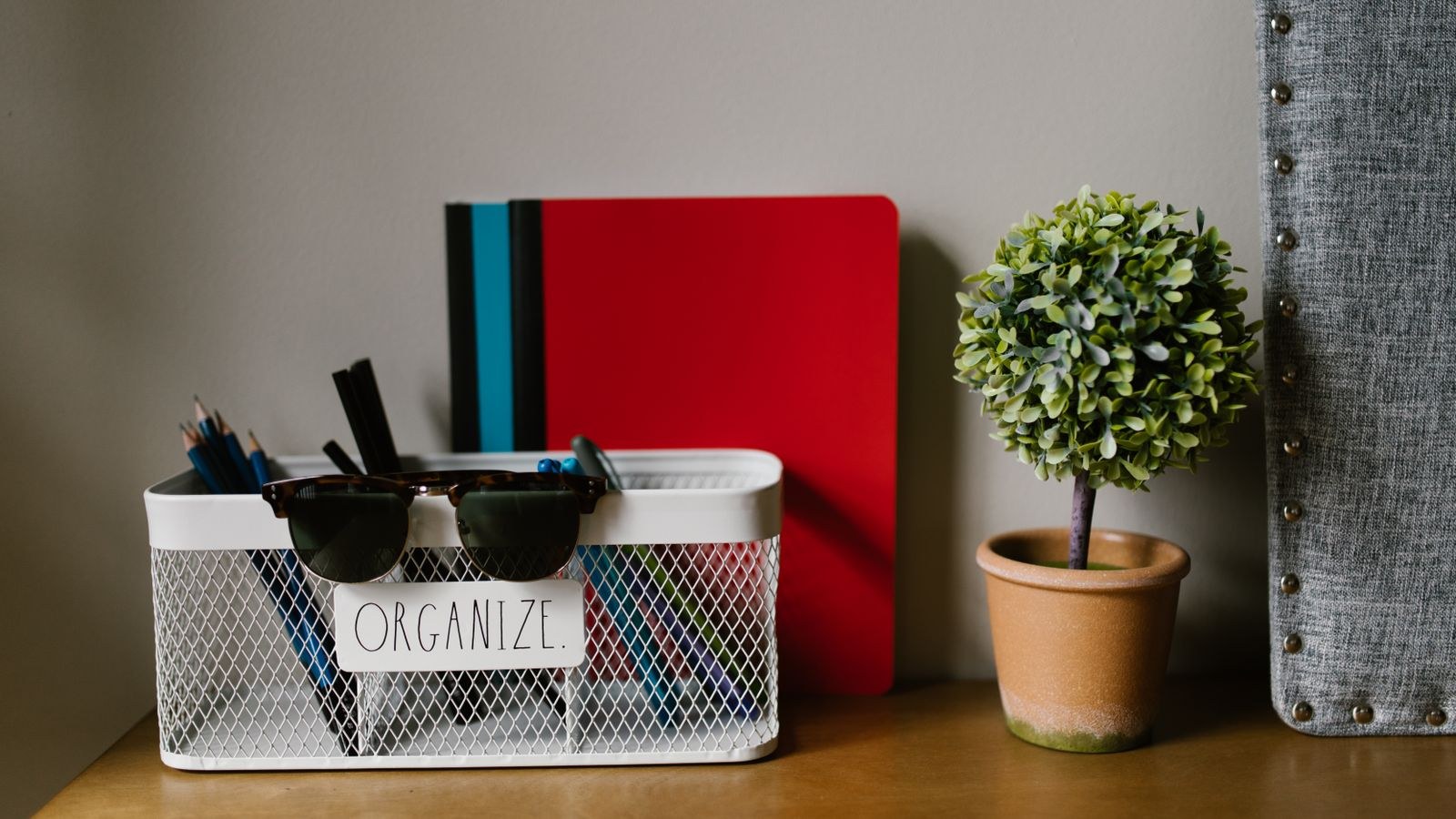 Desk organizer basket holding supplies in the secondary reach zone