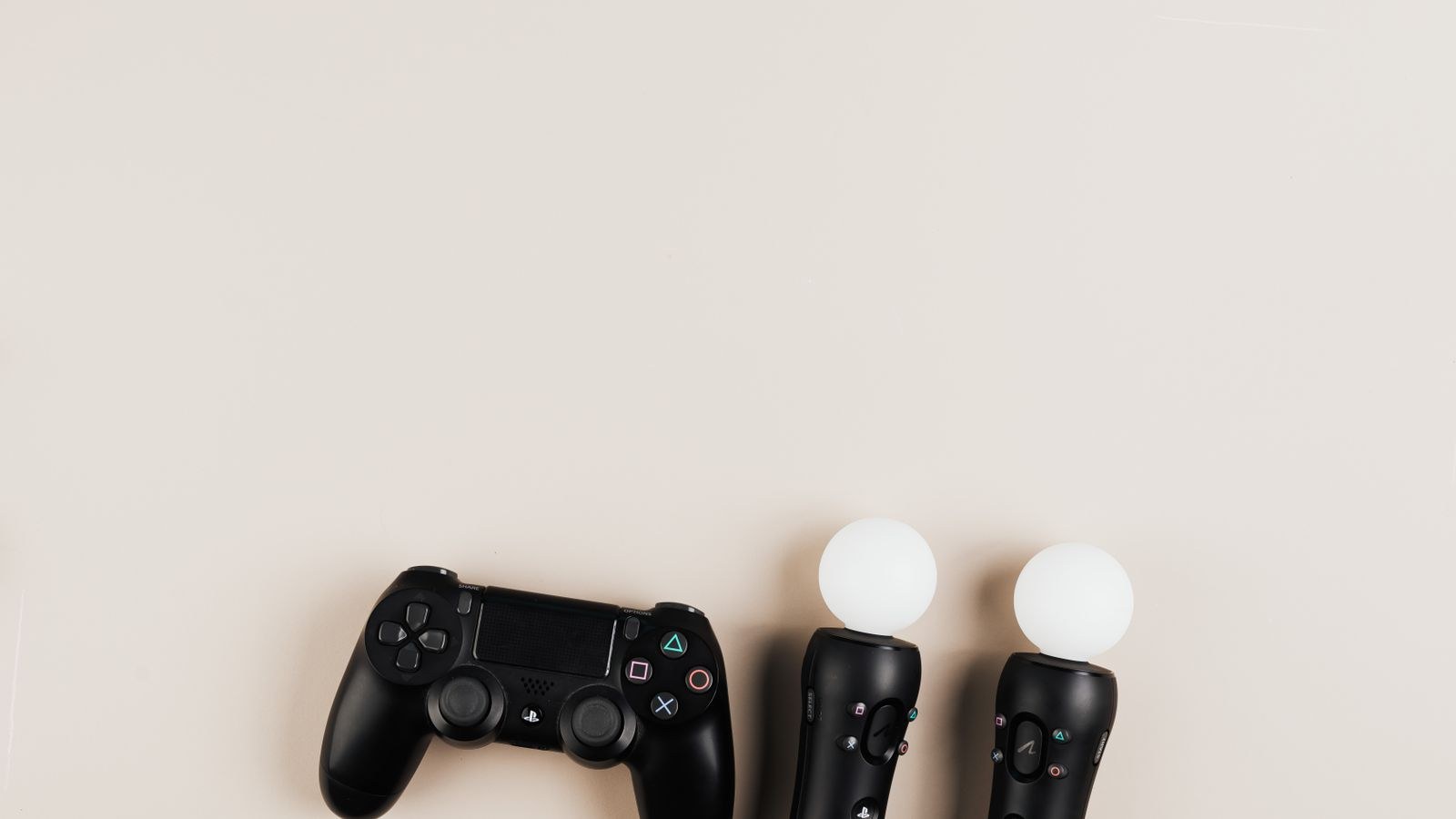 Black gaming controllers arranged on a light background