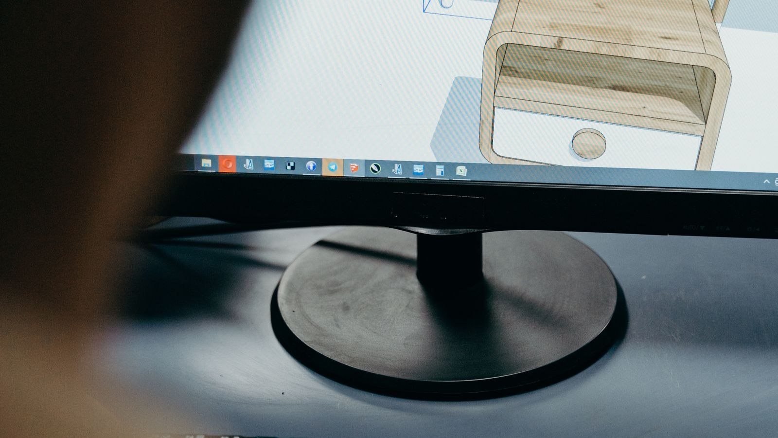 Engineer working on CAD design at a professional computer workstation