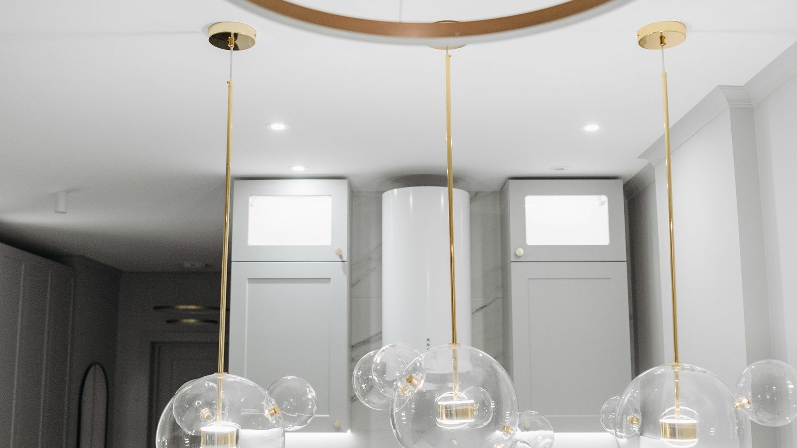 Kitchen with pendant lights hanging above a counter at proper height