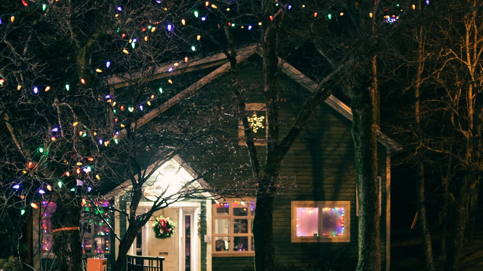 Colorful exterior lighting on a house facade during the holiday season