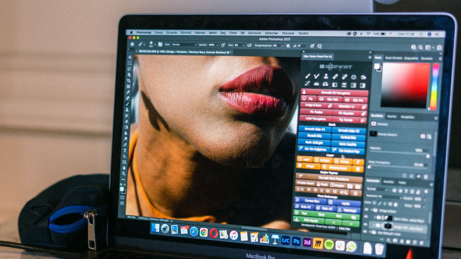 Photographer editing images on a desktop computer with dual monitors