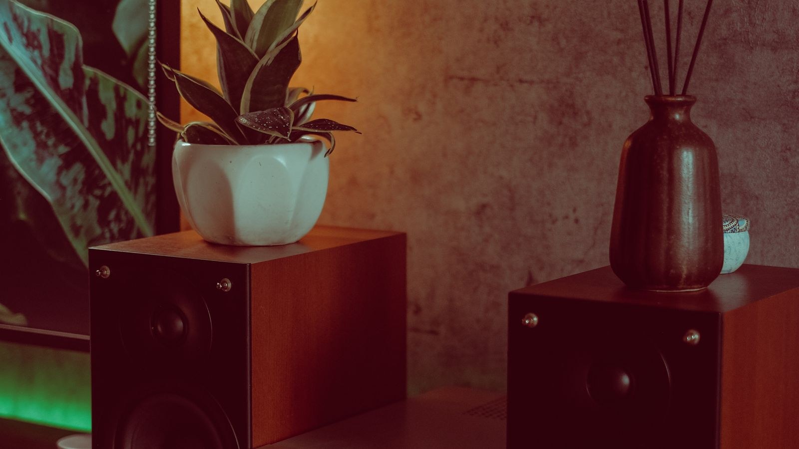Living room corner with speakers and a subwoofer beside furniture