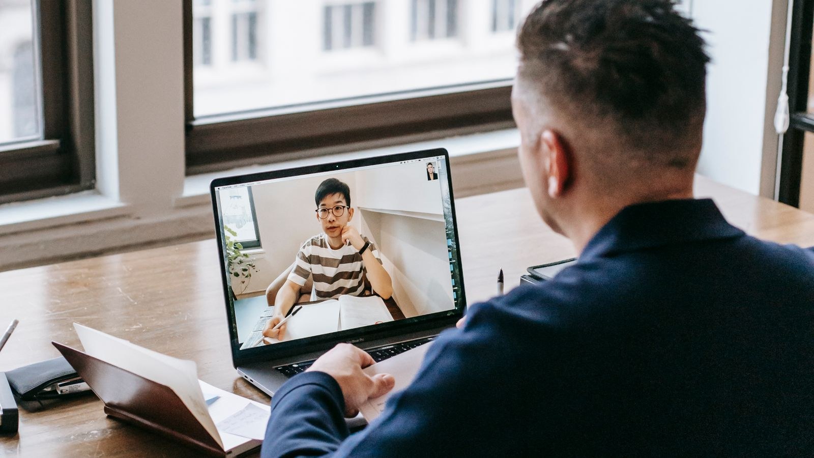 Person on a stable home video call while other devices stream in the background