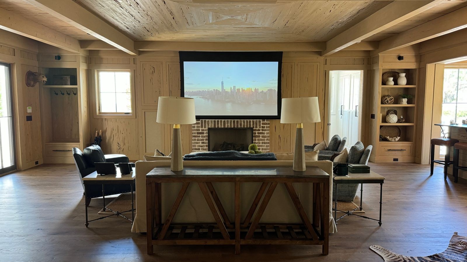 Stylish living room with a large projector screen and cozy seating for movie night