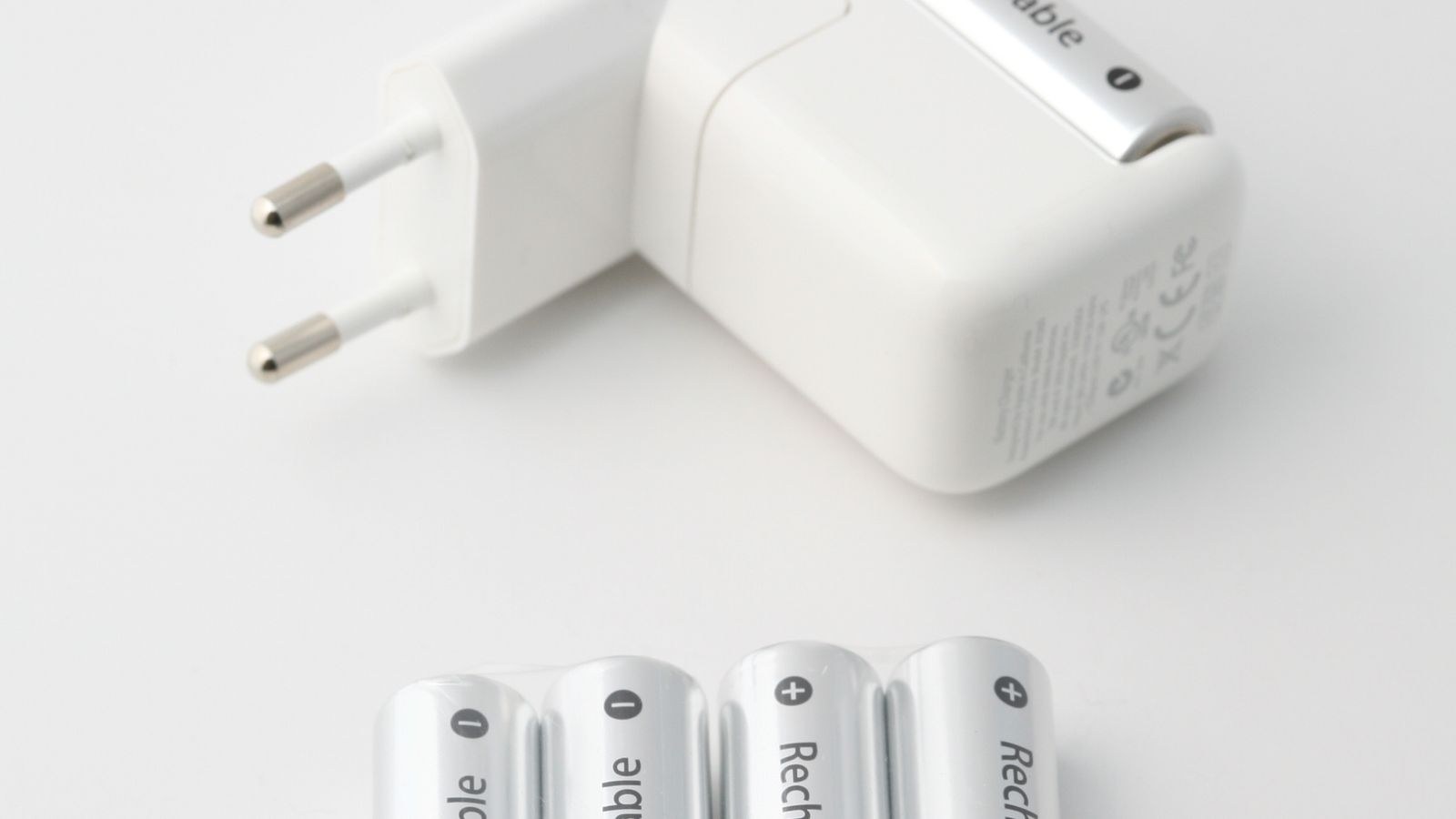 Battery charger with rechargeable batteries on a white background