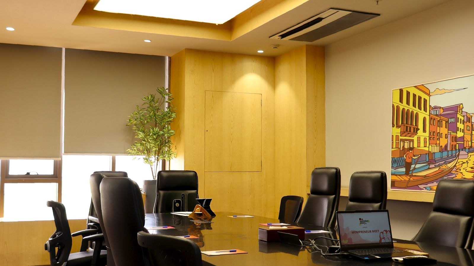 Spacious room with reclining ergonomic chairs around a sleek table