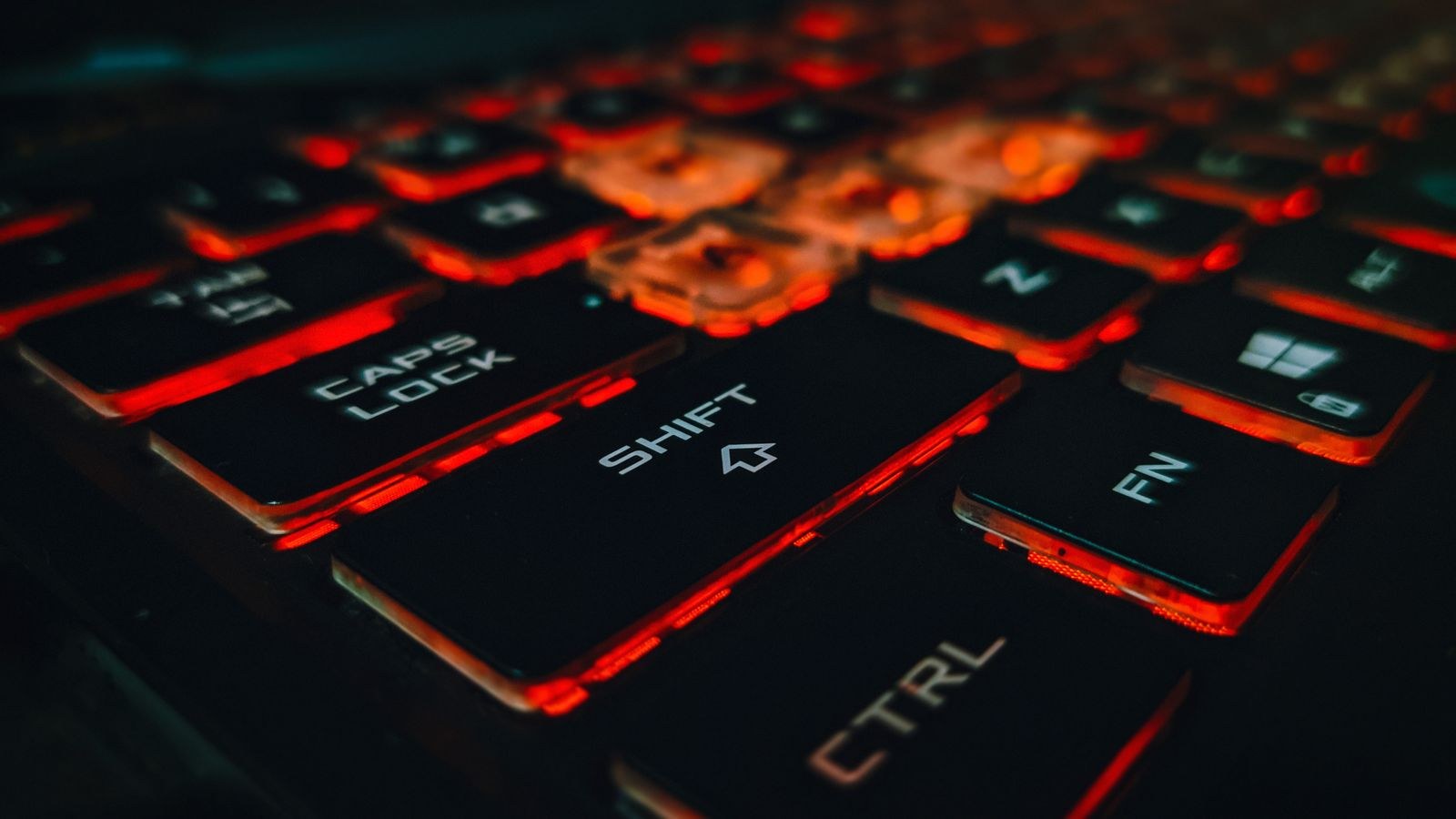 Close up of an RGB gaming keyboard with glowing red keys for macro binding