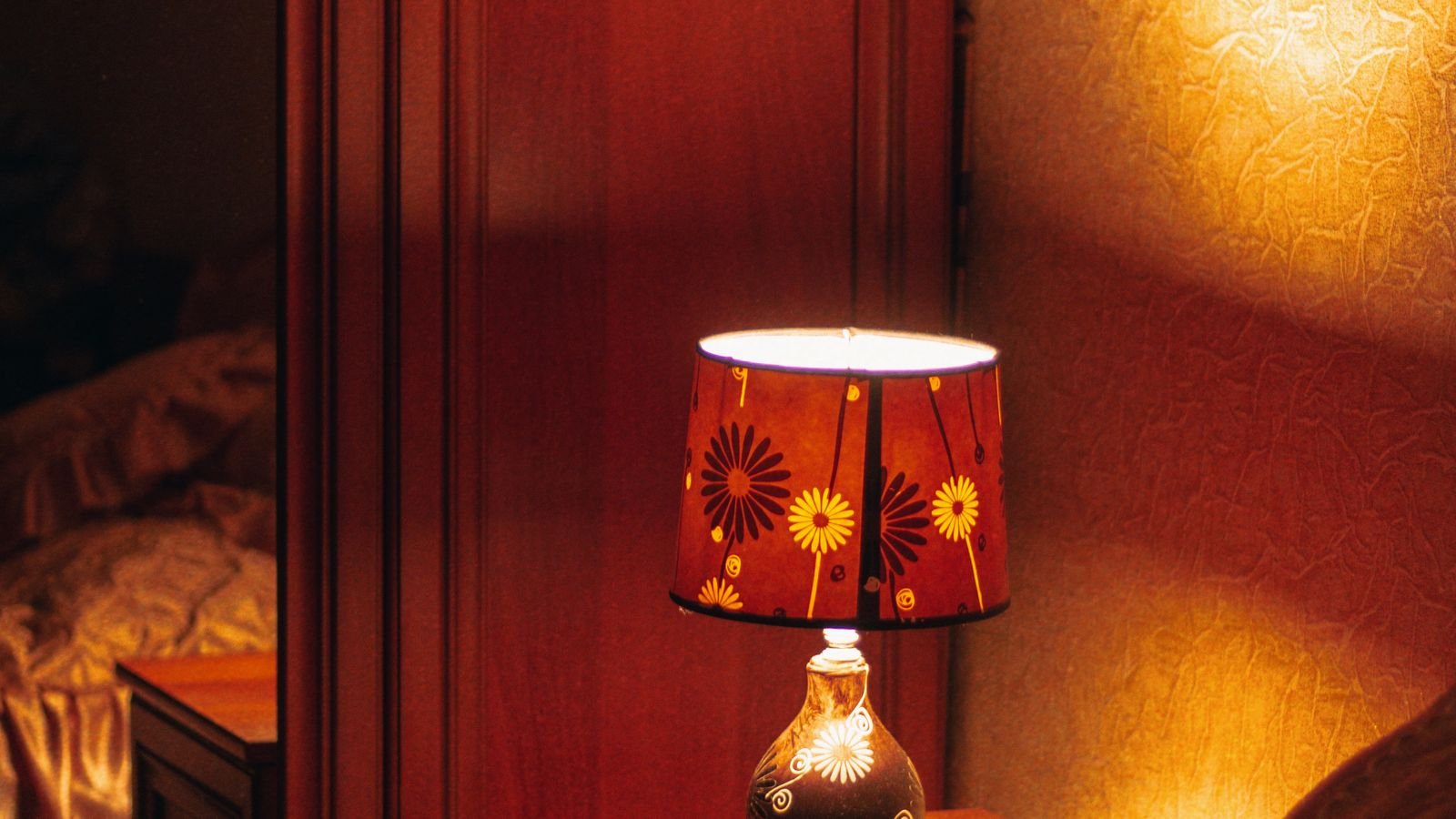 Bedside lamp with warm low blue light bulb on a nightstand