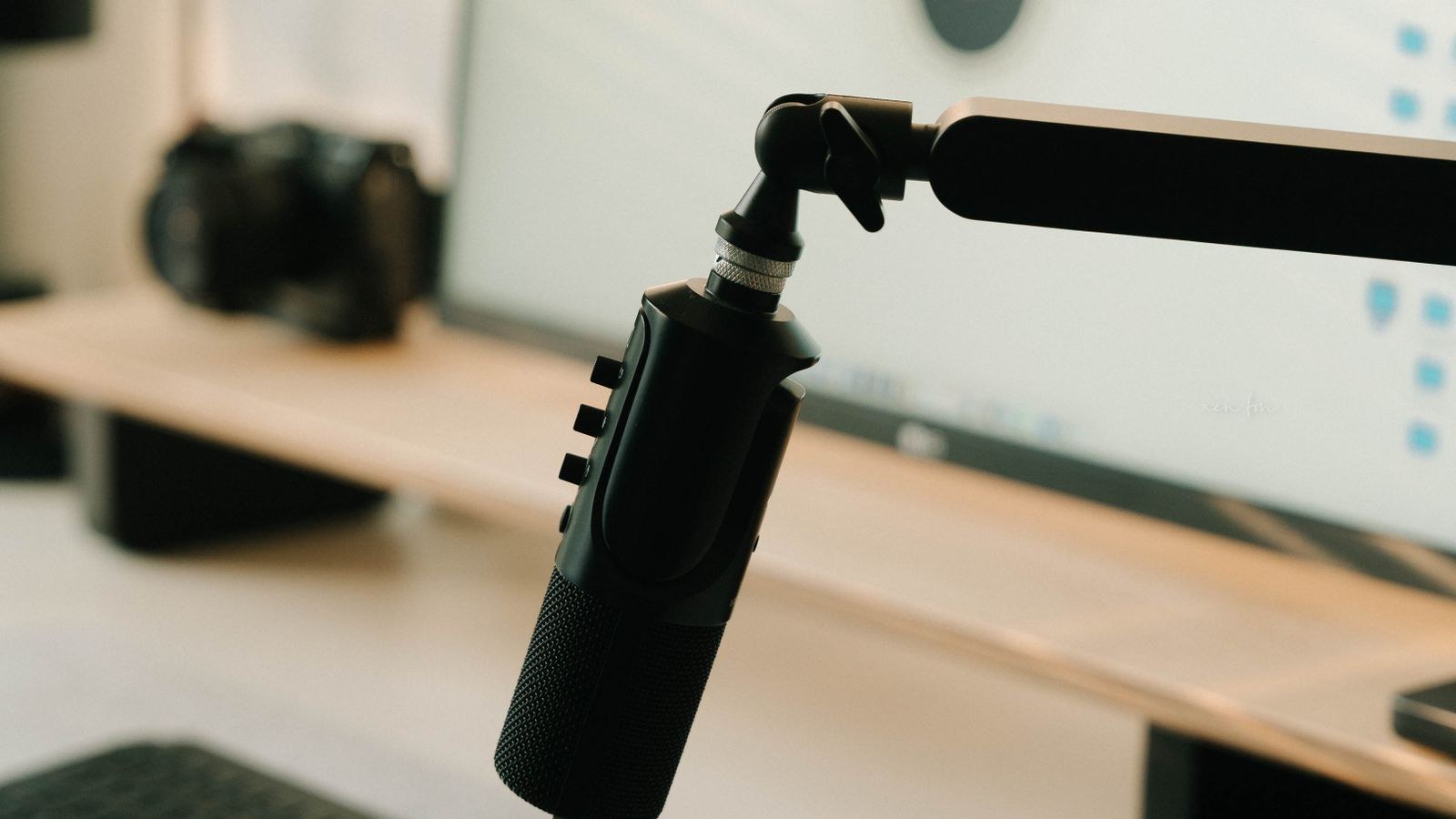 Person using a noise cancelling headset with boom microphone in a home office