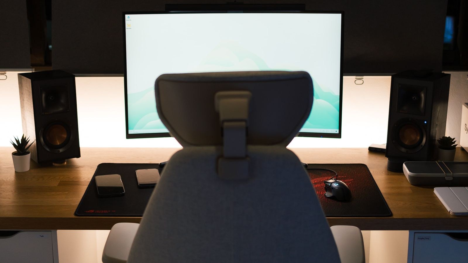 Home office setup with ergonomic chair, desk and computer screen
