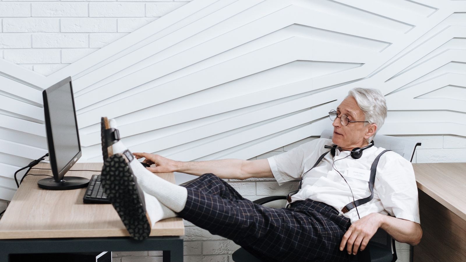 Man taking a break at his desk with feet elevated to relieve leg swelling