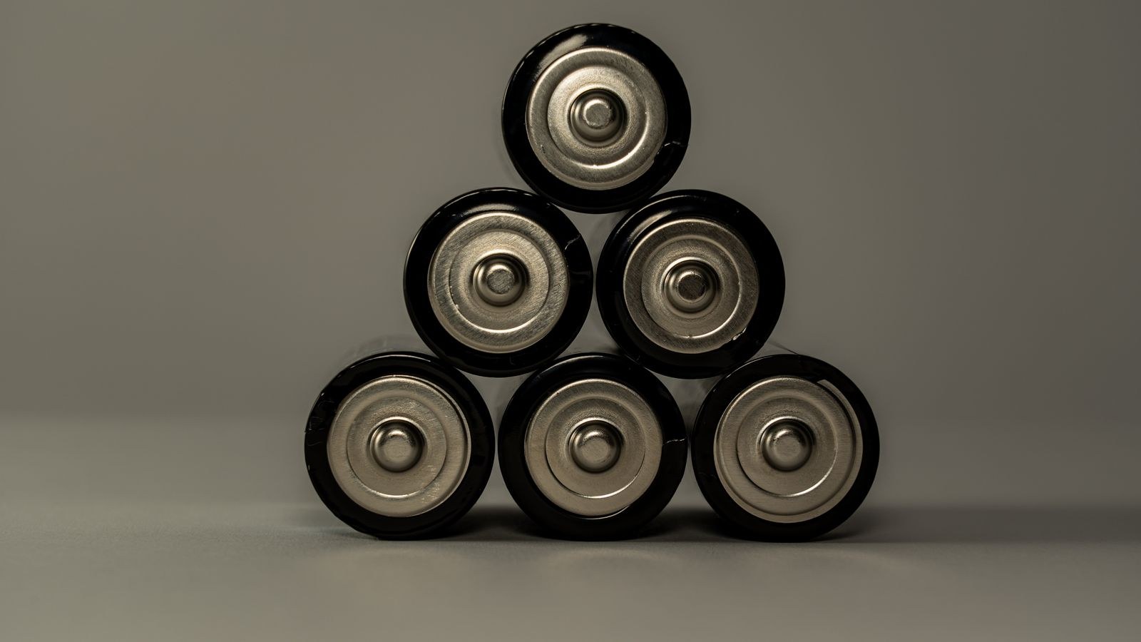 Stack of AA batteries representing spare cells kept for a smart lock