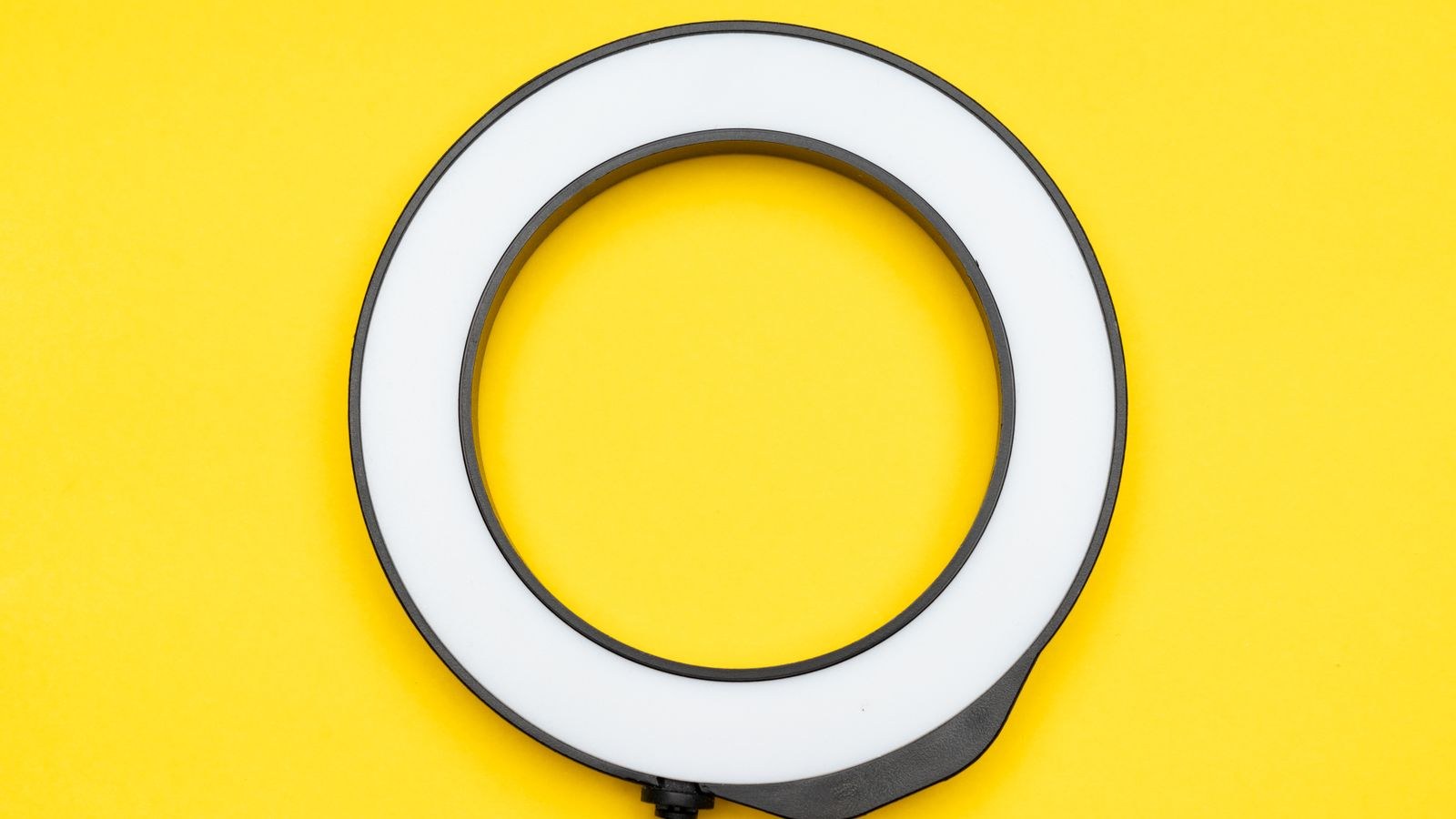 Close up of a circular LED ring light against a bright background