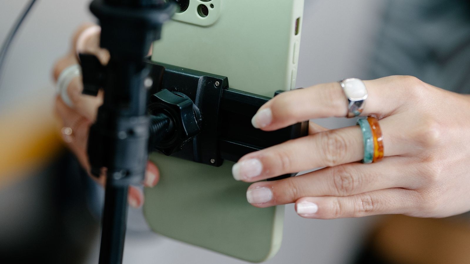 Smartphone mounted on a tripod with a ring light set up for filming