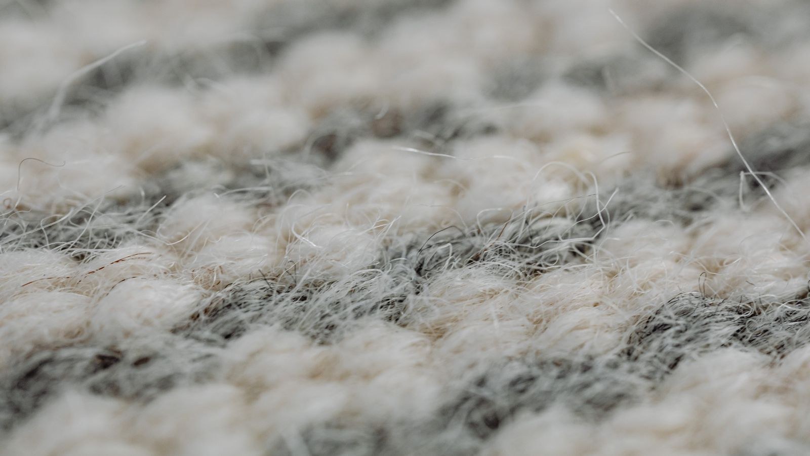 Woven natural fibre rug with visible texture on a wooden floor
