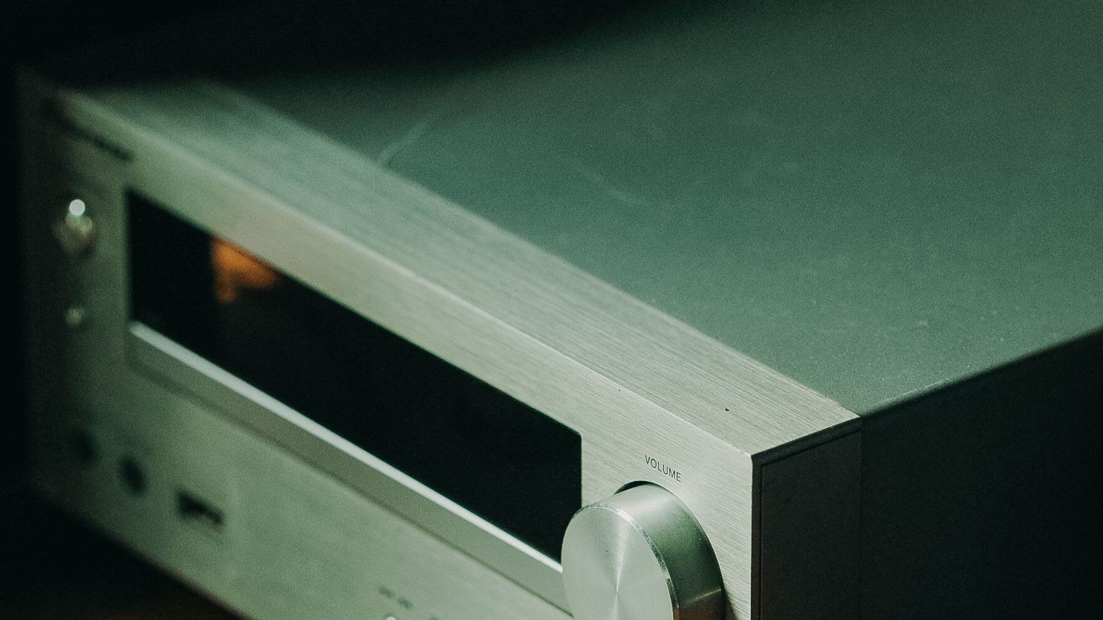 Silver stereo receiver with calibration microphone connected for room setup