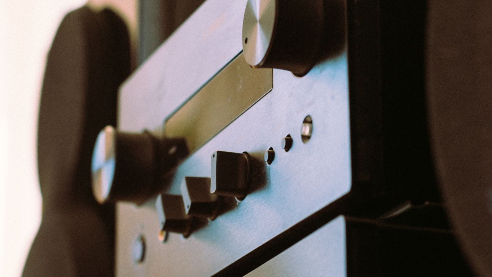 Black audio stereo system control knobs on an AV receiver front panel