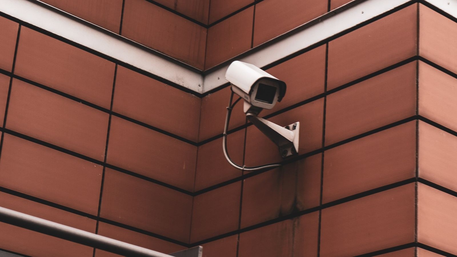 Surveillance camera mounted on an interior wall of a building
