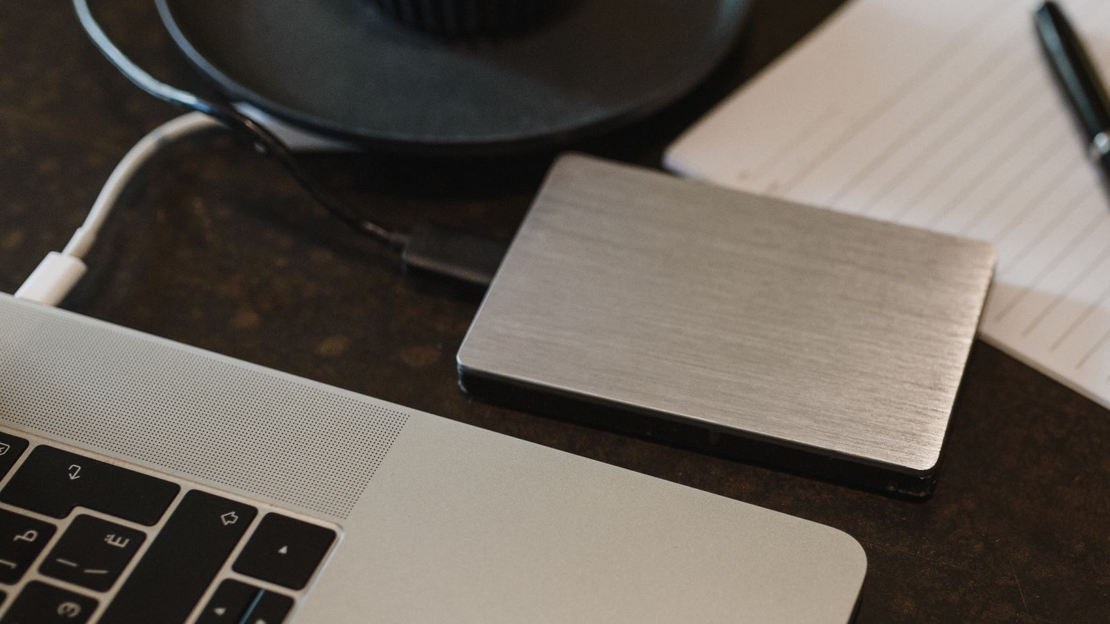 External hard drive connected to a laptop for reviewing recorded footage