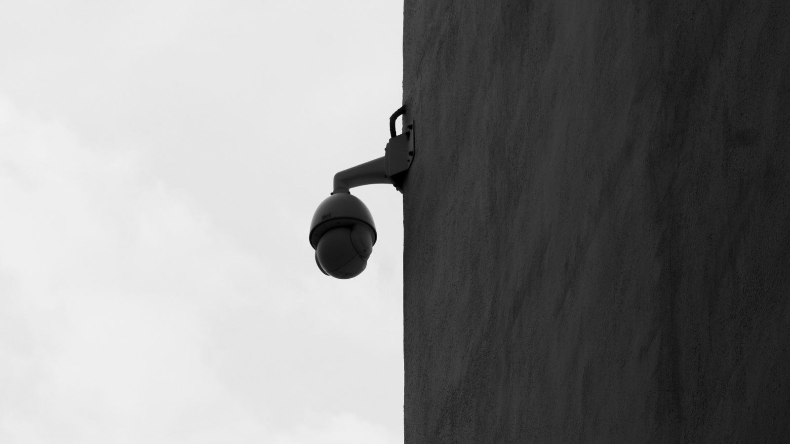 Close up of a dome security camera housing showing weather sealing and lens cover